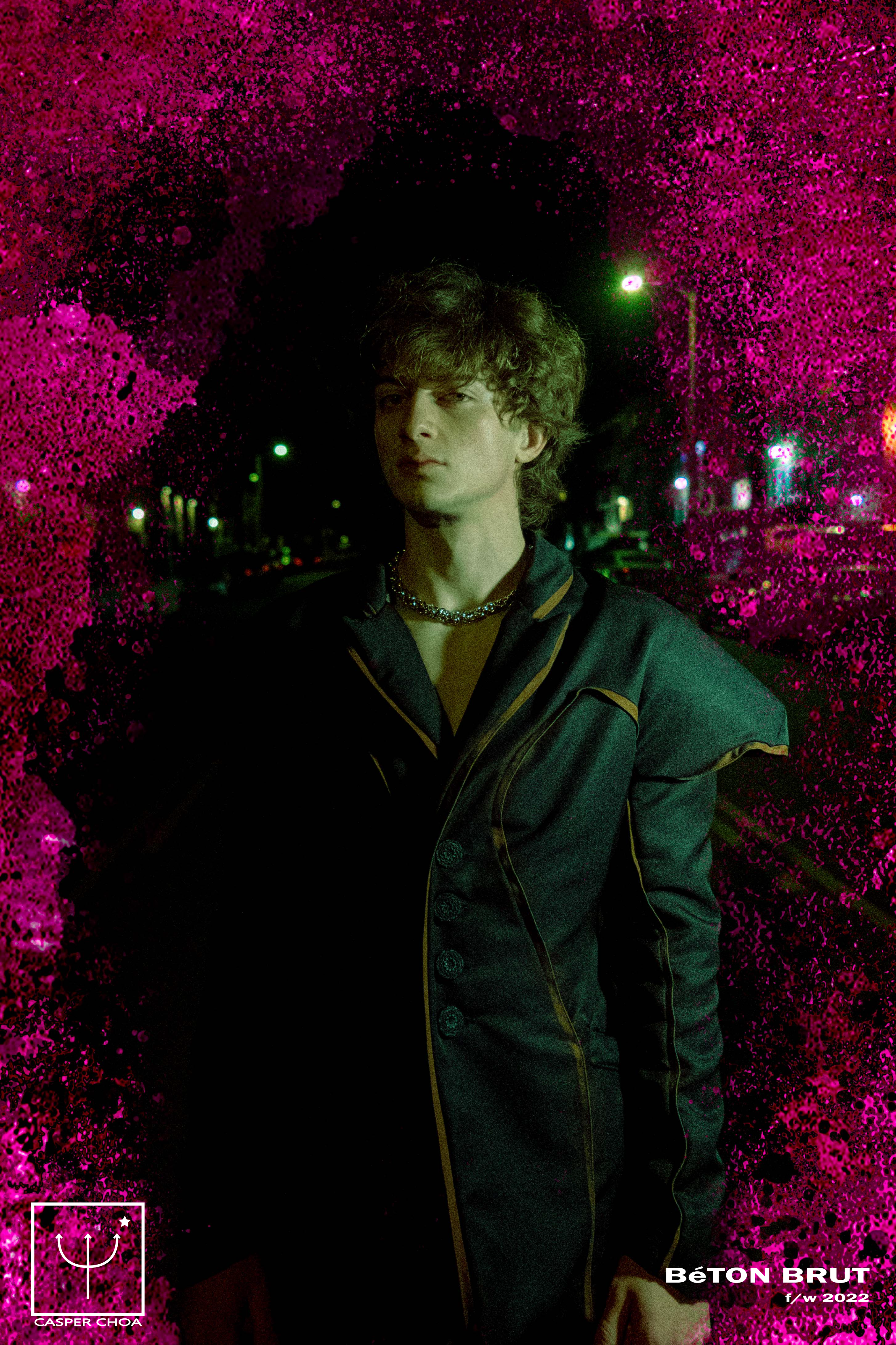 picture of man in black avant garde blazer and black pants with pink border