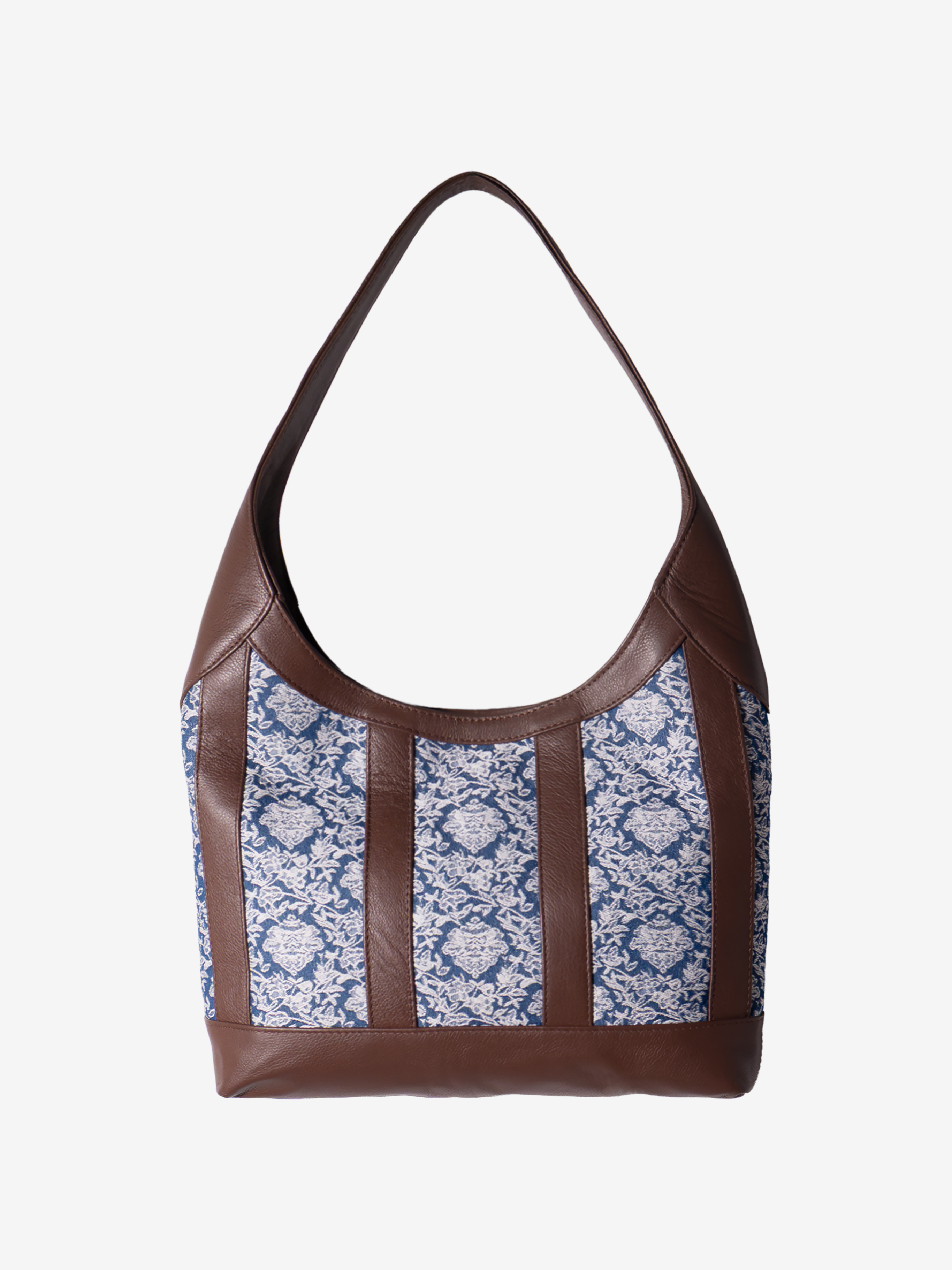 Brown leather handbag with blue/white floral jacquard on a white background