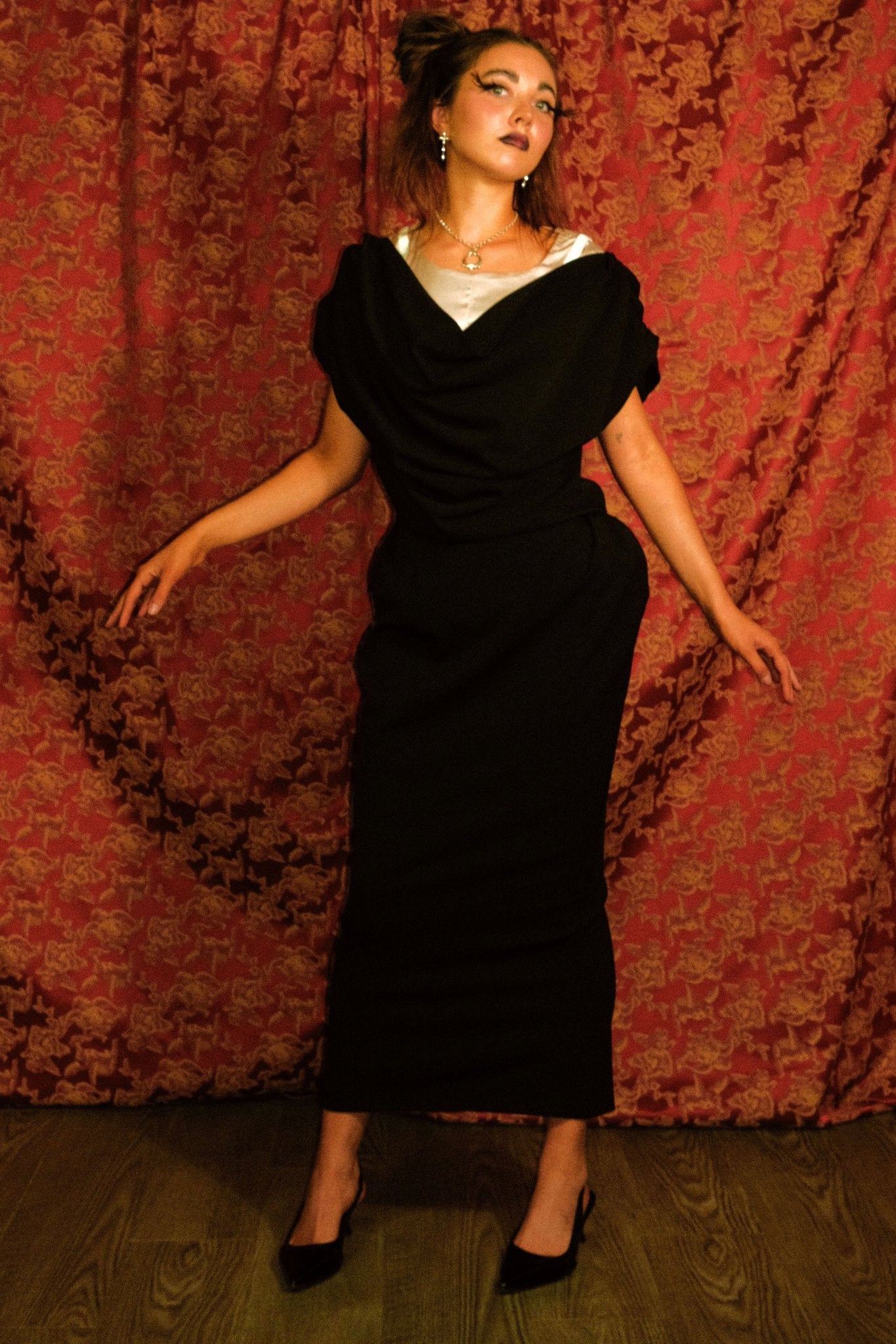 picture of woman in black top and skirt